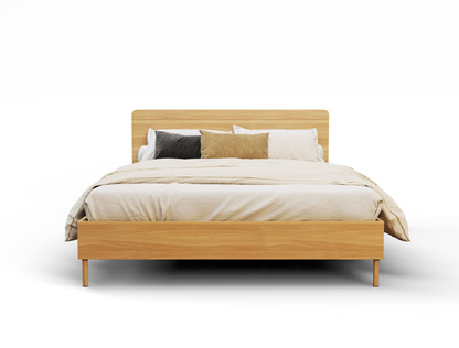 front view of a double bed frame with mattress and pillows in a white background from Isaak