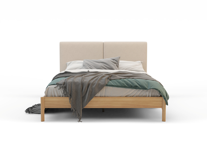 front view of a king bed frame with mattress and pillows in a white background from Isaak