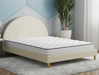 side view of a double mattress on a bed frame in a bedroom from Isaak