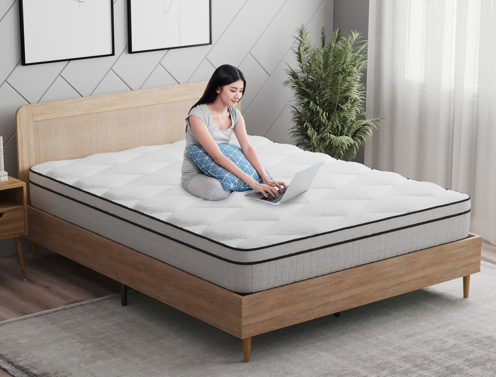 woman working on a laptop on a double mattress on a bed frame in a bedroom from Isaak