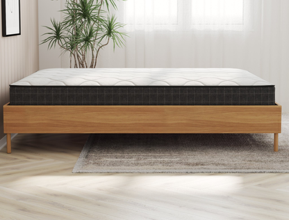 side view of a king mattress on a bed frame in a bedroom