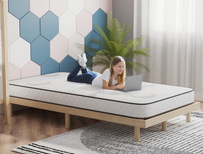 kid using a laptop on a double mattress on a bed frame in a bedroom from Isaak