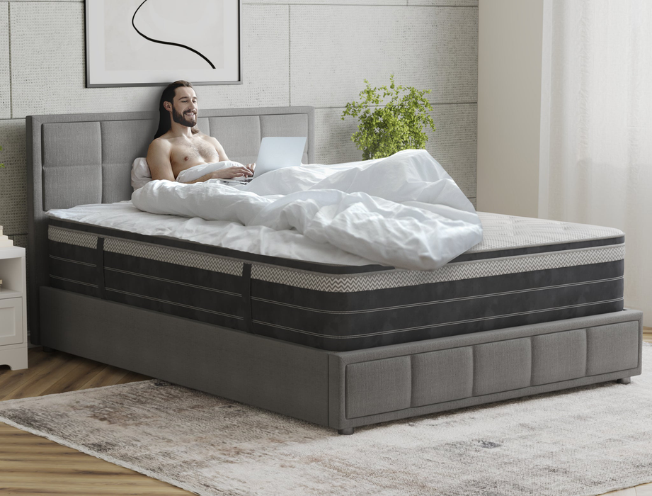 man laying on a king single mattress on a bed frame in a bedroom from Isaak