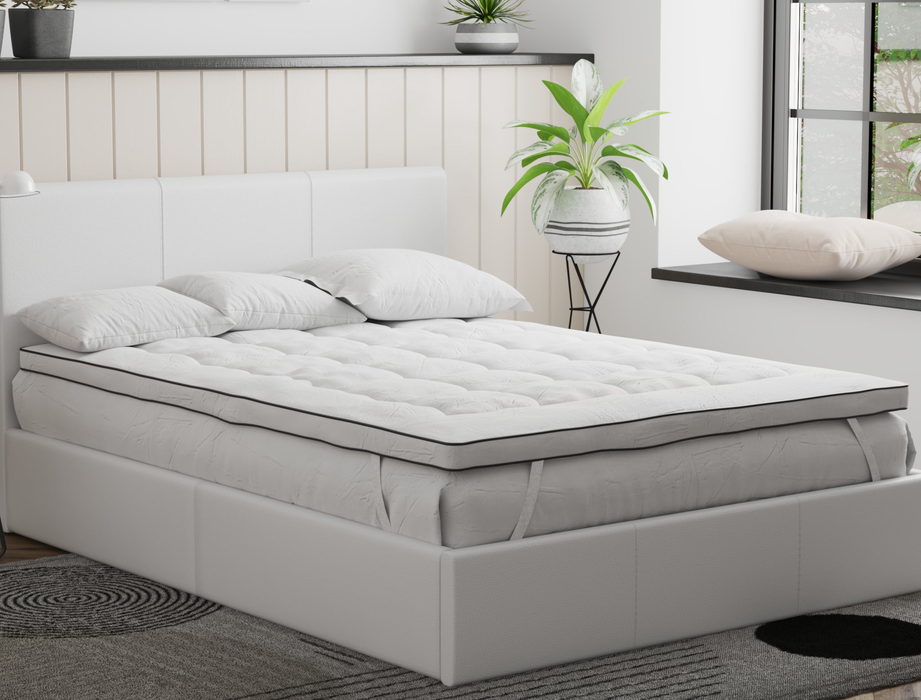 top view of a king single mattress topper with three pillows on a bed frame in a bedroom from Isaak