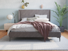 front view of a queen bed frame with mattress and pillows in a bedroom from Isaak